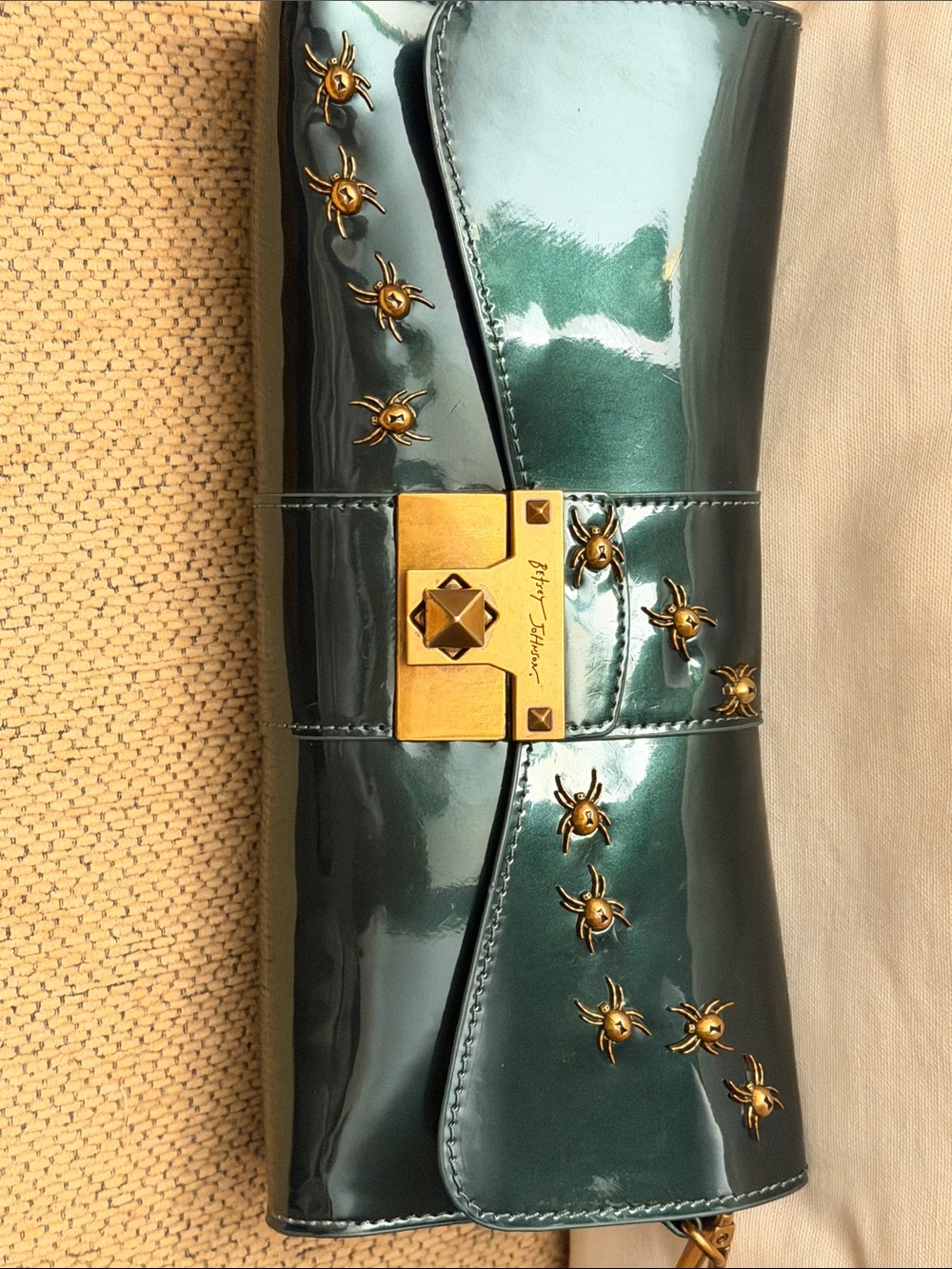 Betsey Johnson glossy dark emerald patent clutch with gold studs